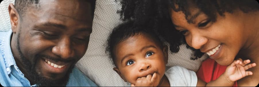 Family laying down with baby